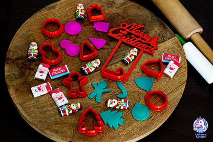 Set of mini Christmas cookie cutters, including a cake topper saying Merry Christmas. The scene is decorated with mini Christmas chocolates
